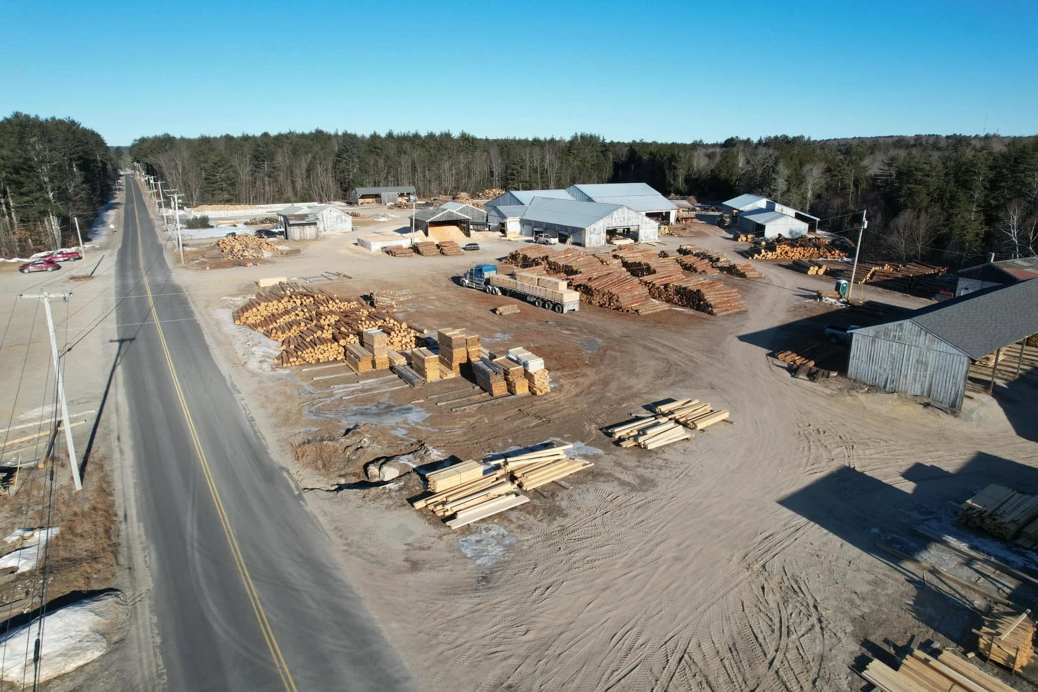 Aerial view of the Maschino & Sons yard with lumber and equipment